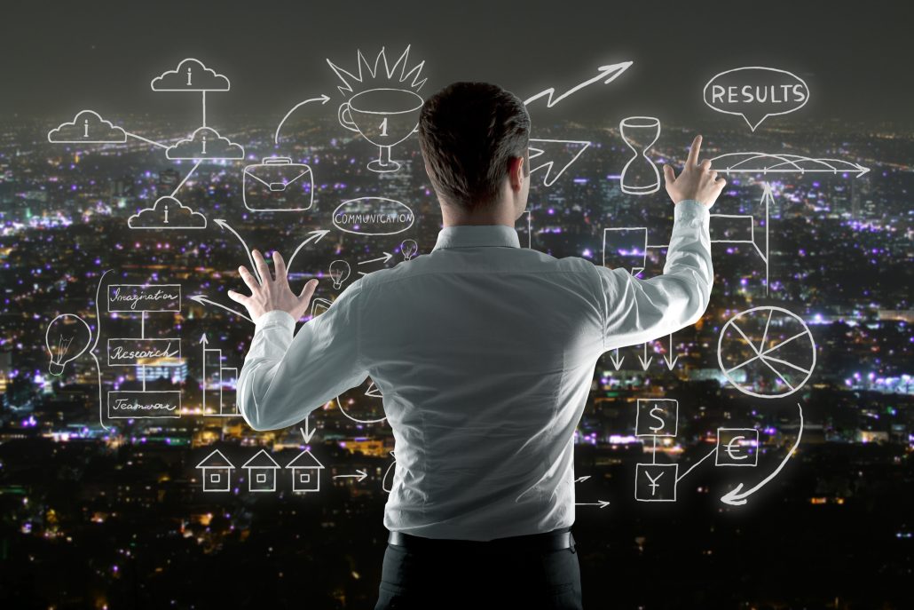 Businessman managing abstract business sketch on night city background